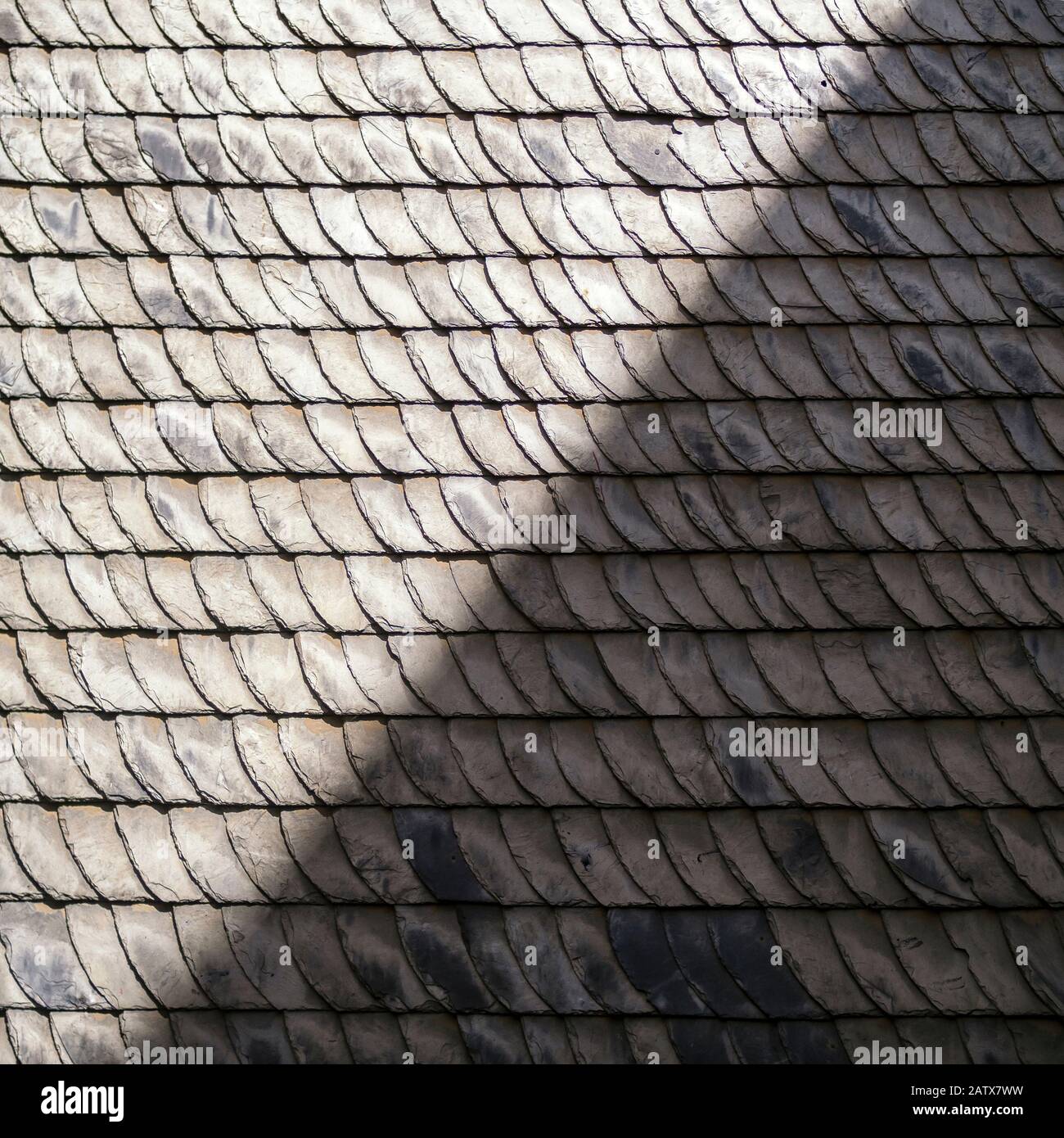 TEXTURE - Slate roof half in sun and half in shade Stock Photo