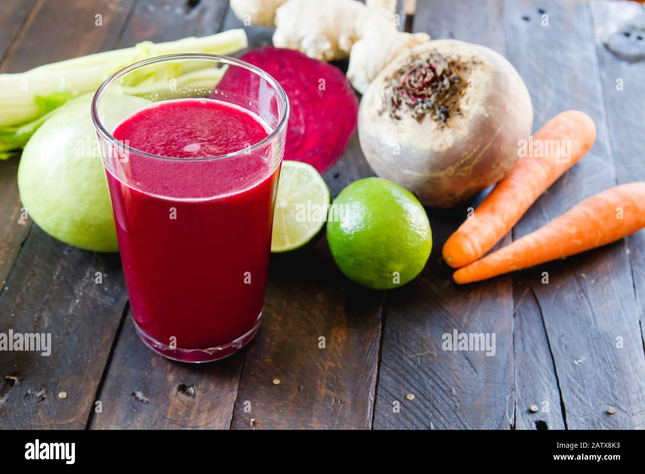A glass with fresh homemade detox beetroot juice and ingredients Stock Photo
