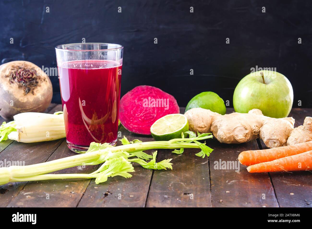 A glass with fresh homemade detox beetroot juice and ingredients Stock Photo