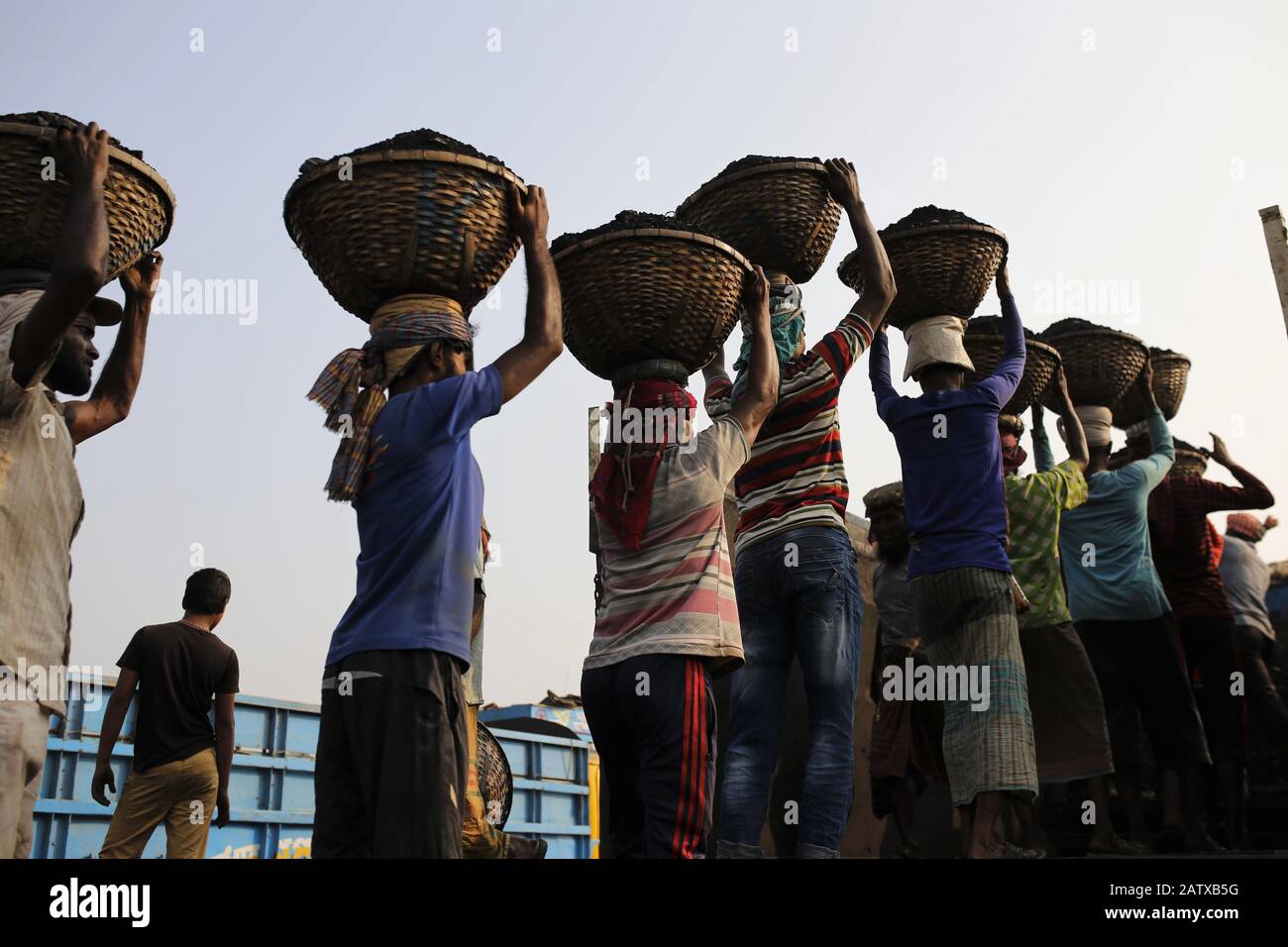 Dhaka, Bangladesh. 5th Feb, 2020. Laborers load coal from a barge in a basket on their head at the bank of the Turag River. Credit: MD Mehedi Hasan/ZUMA Wire/Alamy Live News Stock Photo