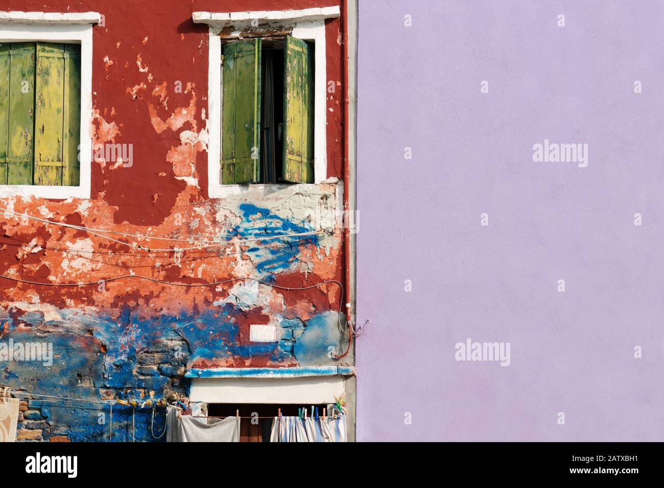 rugged and smooth wall with crack wooden window on colorful cement background Stock Photo