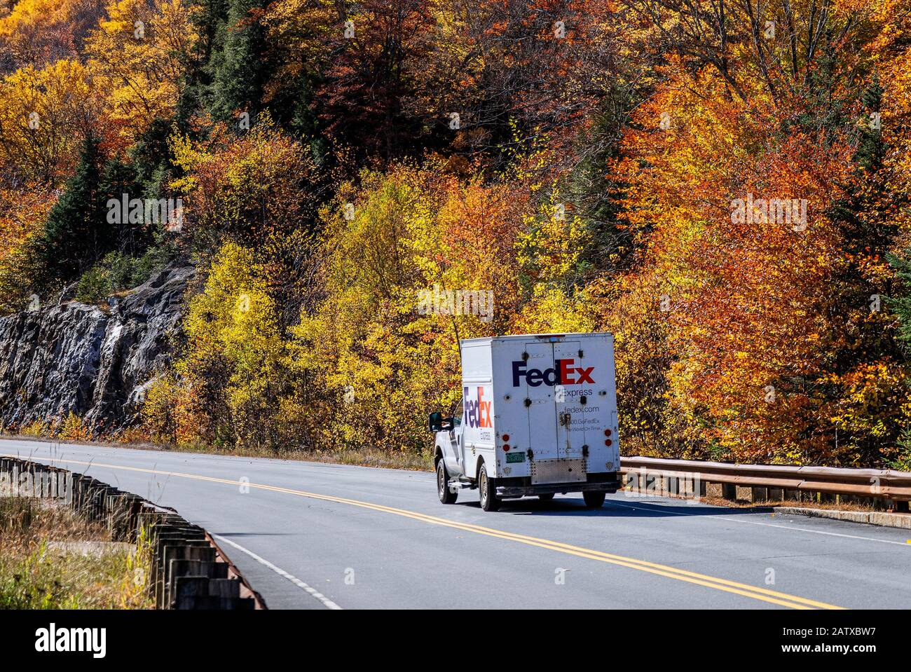 FedEx delivery truck making autumn delivery. Stock Photo