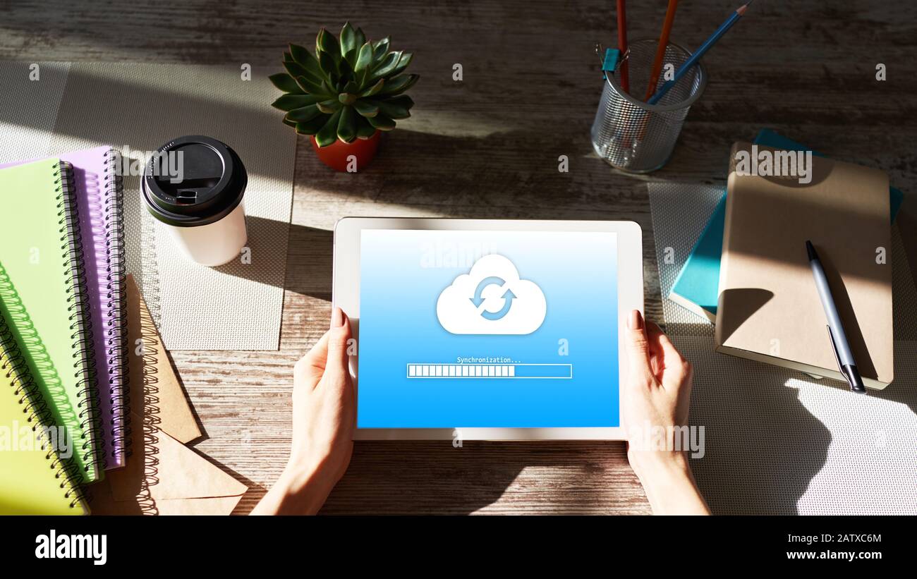 Cloud synchronization progress bar on tablet screen. Data storage and protection. Technology and internet concept Stock Photo