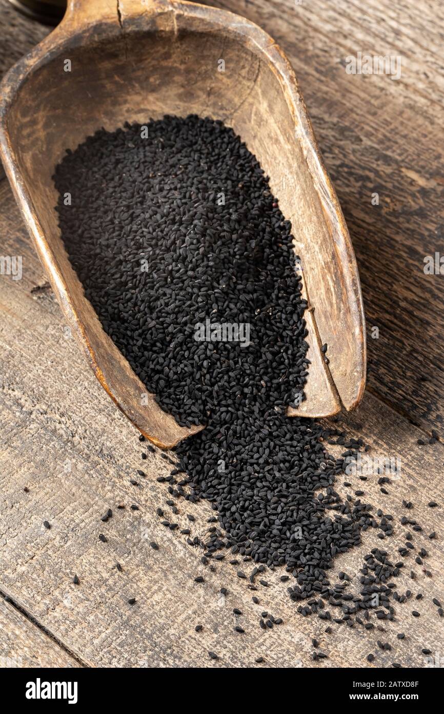 Black cumin seeds on a scoop, top view Stock Photo