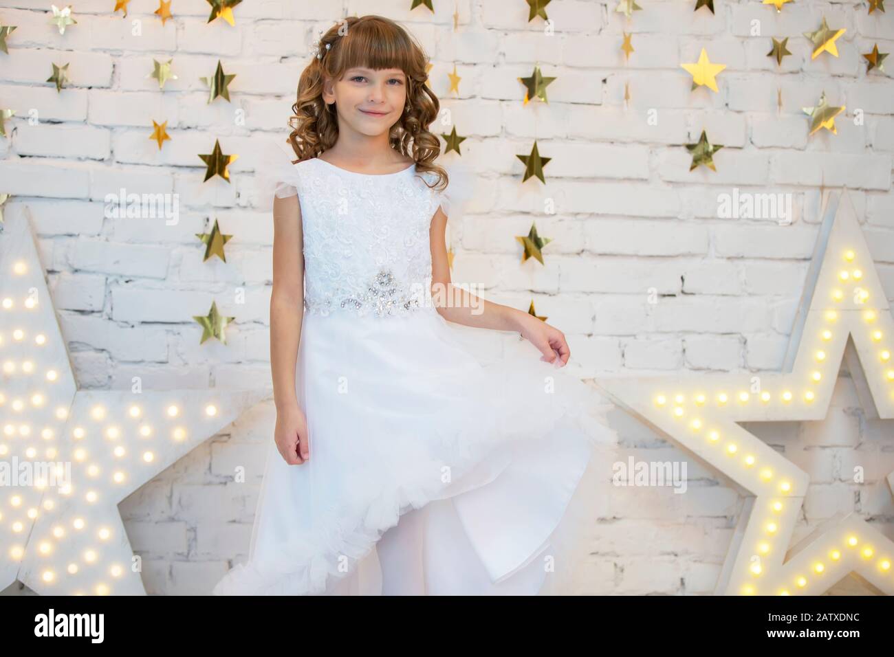 Elegant child in a white dress. Little girl model posing Stock Photo Alamy
