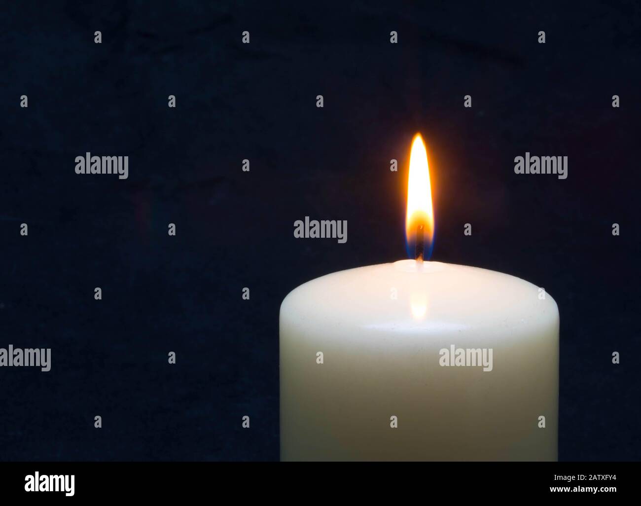 Burning candle on dark background with space for text. Funeral service Stock Photo
