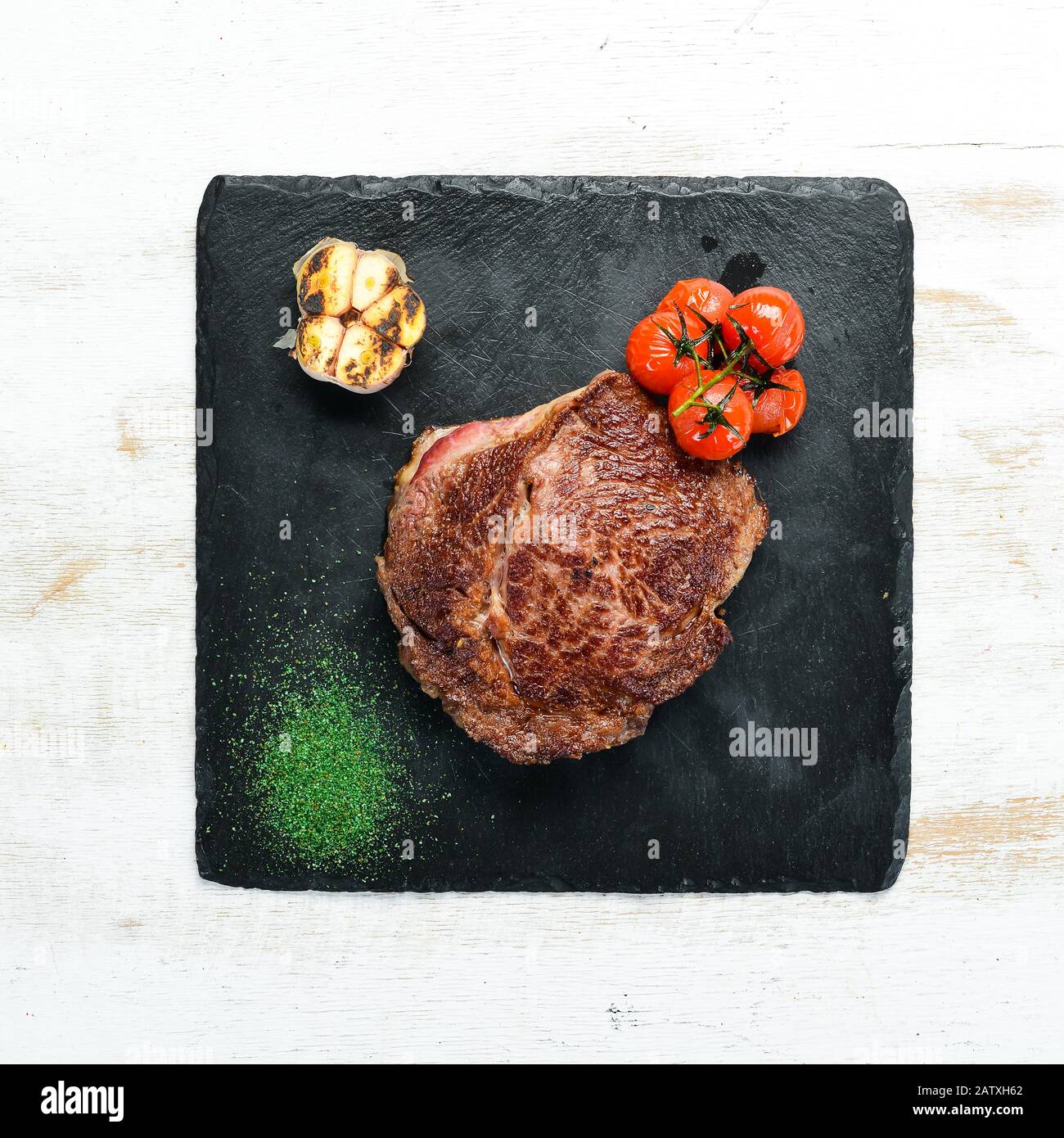 Grilled Ribeye Steak on the old background. Top view. free space for ...