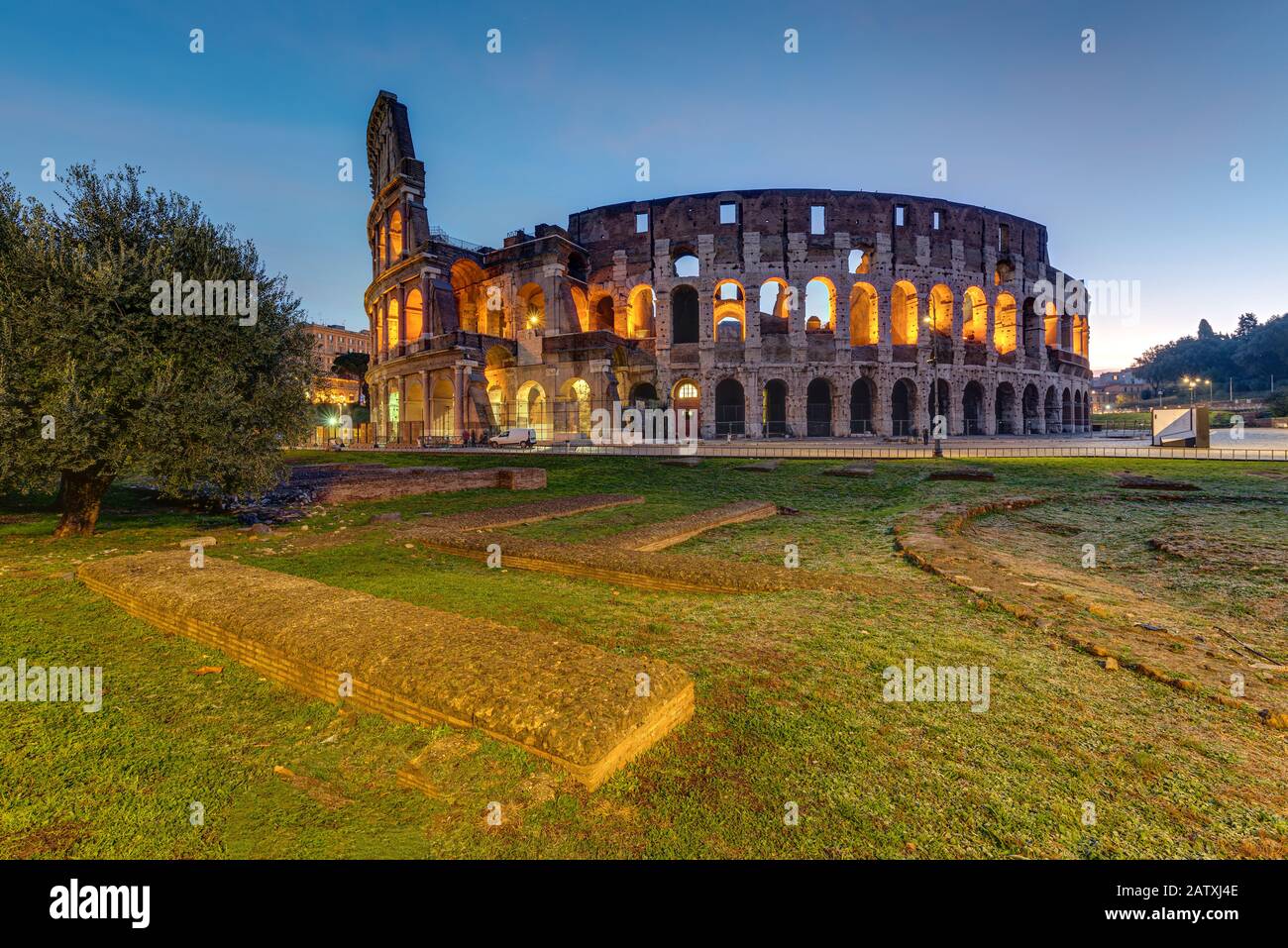 The illuminated Colosseum in Rome before sunrise Stock Photo