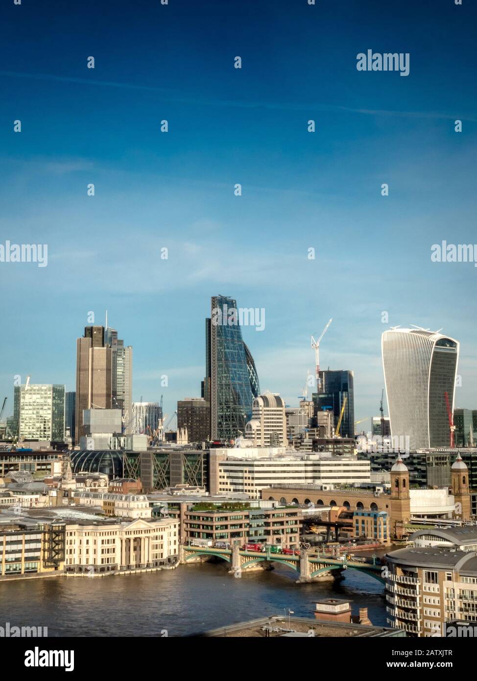 City of London. Landmark skyscrapers in the financial district of the UK capital with the River Thames in the foreground. Stock Photo