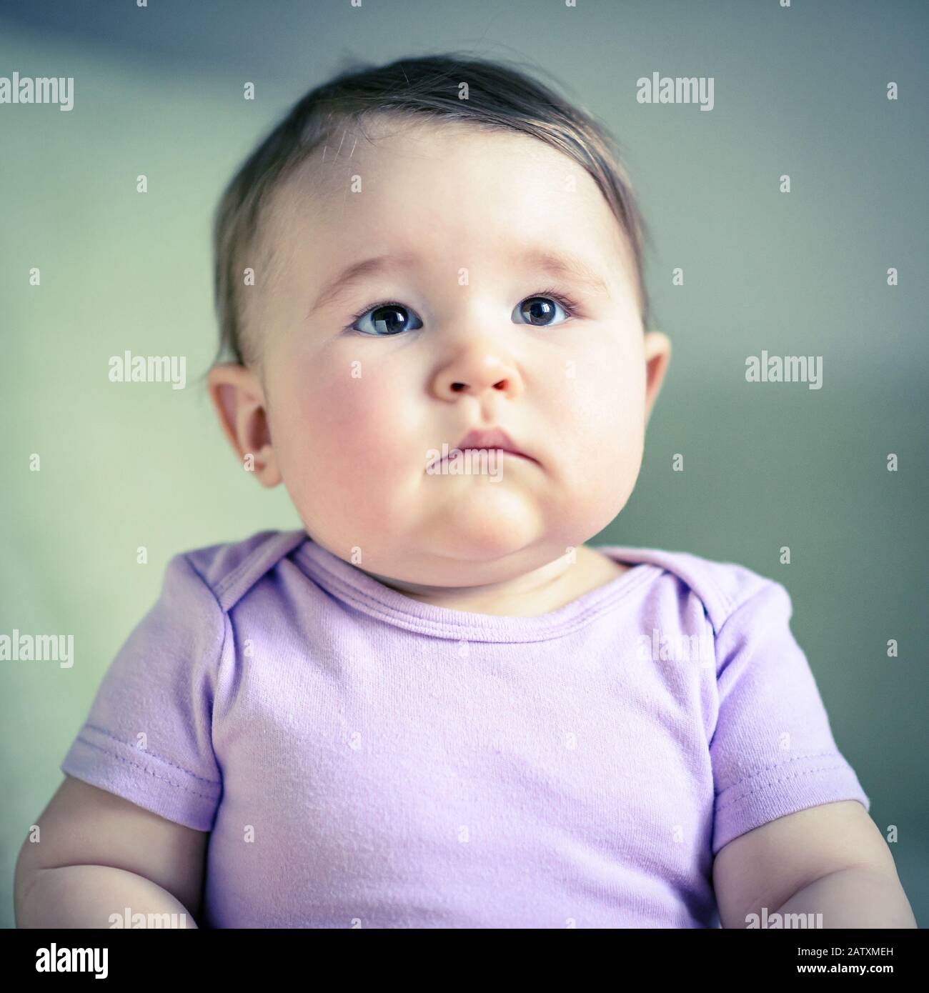 Thoughtful and serious nice baby girl, child close-up Stock Photo