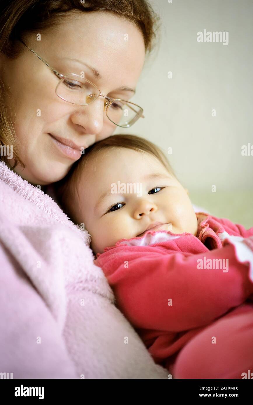 Mother hugging baby. Mother and daughter, happy family. Stock Photo