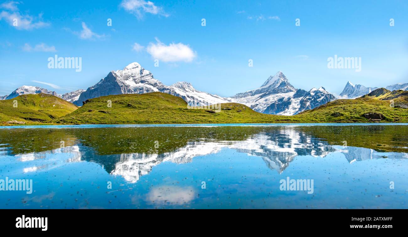 Summits Schreckhorn and Finsteraarhorn are reflected in the Bachalpsee, Grindelwald, Bernese Oberland, Switzerland Stock Photo