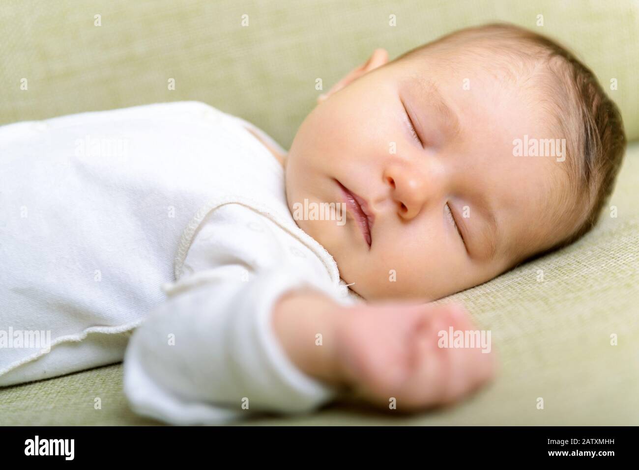 Newborn baby is sleeping peacefully at home Stock Photo