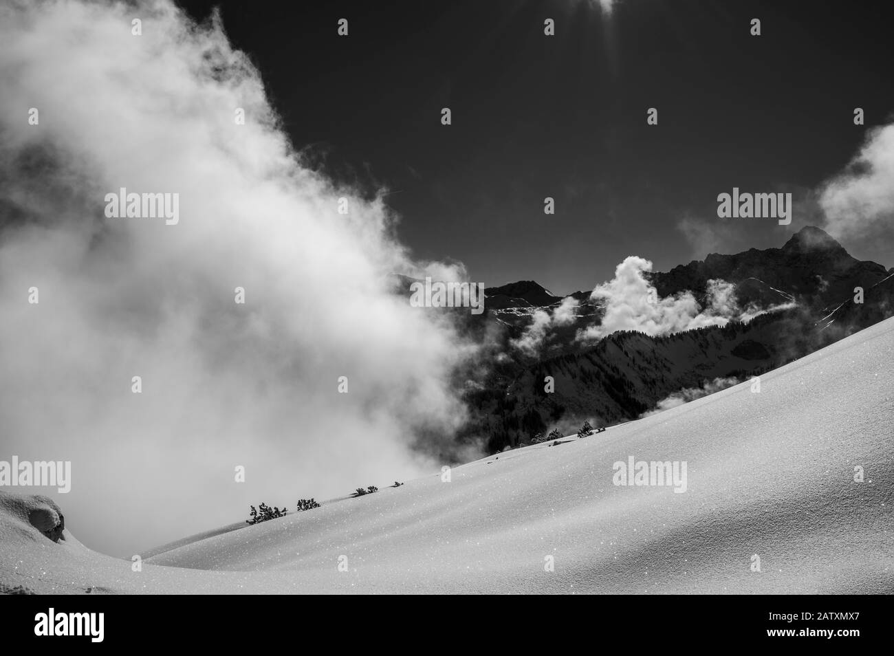Snowy landscape with clouds and Allgaeu Alps, Ritzlern, Kleinwalsertal, Vorarlberg, Austria Stock Photo