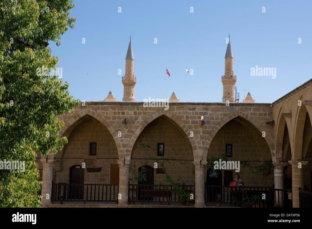 Upper gallery, Büyük Han, the famous caravanserai on Asmaalti Sokak, North Nicosia, Northern Cyprus, with the minarets of the Selimiye Camii beyond Stock Photo