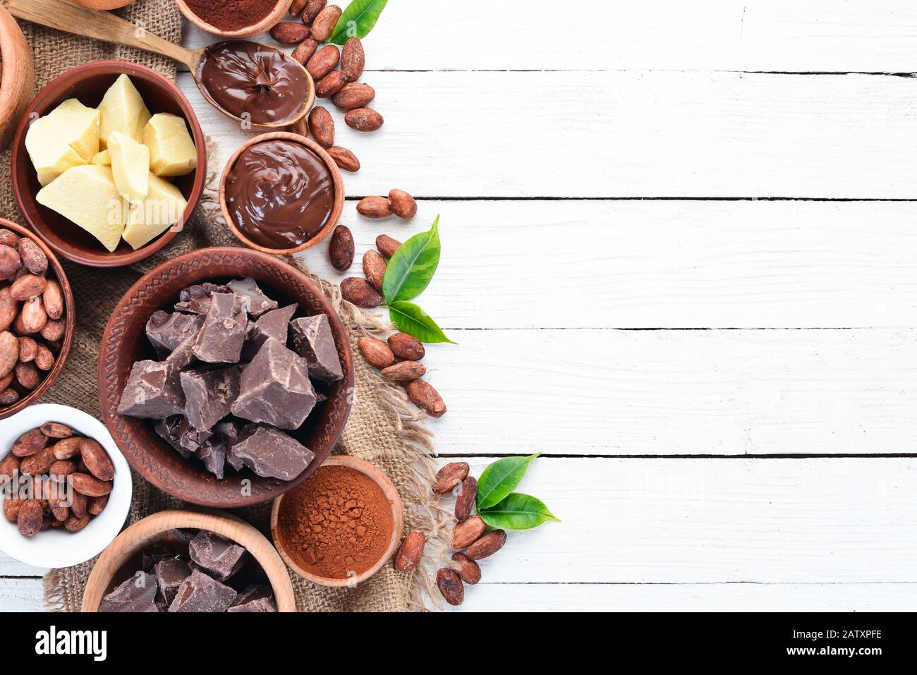 Cocoa beans, chocolate, cocoa butter and cocoa powder on a white wooden  background. Top view. Free copy space Stock Photo - Alamy