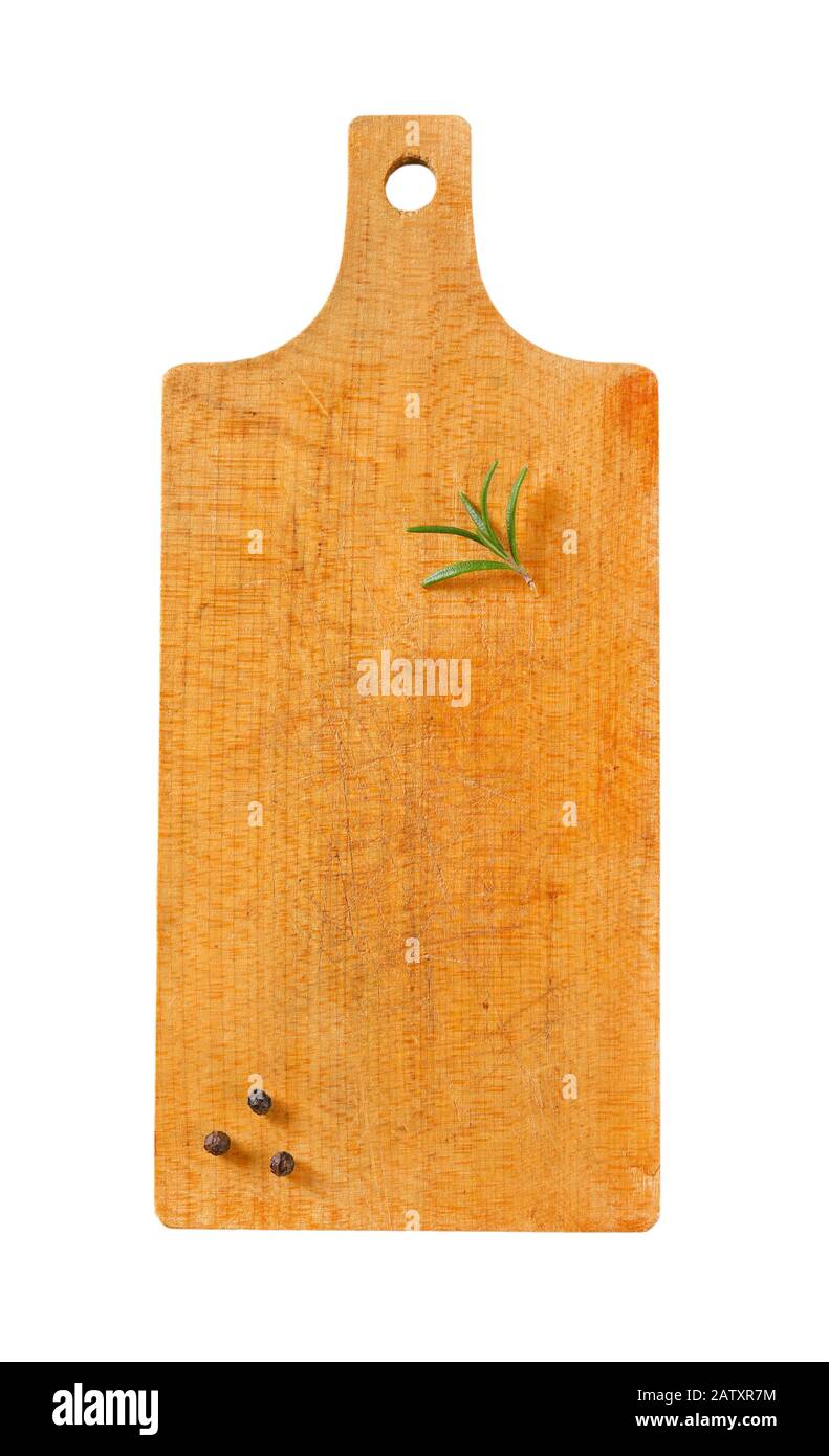 Wooden cutting board with rosemary and black peppercorns on it Stock Photo