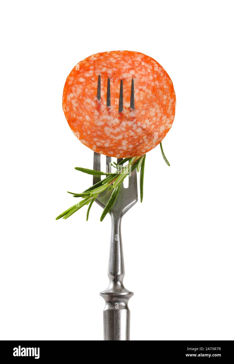 Slice of Hungarian salami and fresh rosemary on fork isolated on white Stock Photo