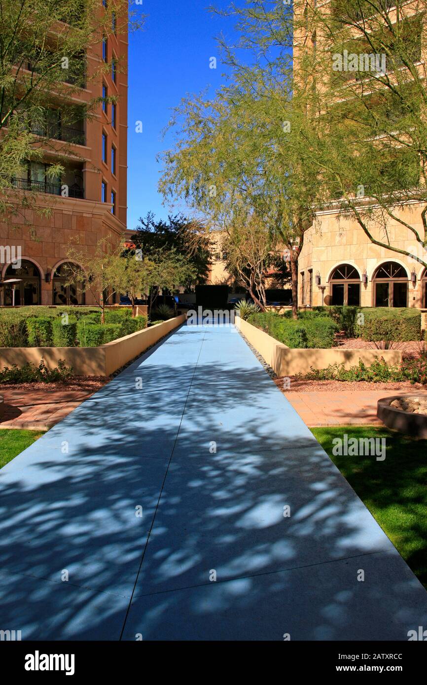 Blue sidewalk between apartment buildings in the Waterfront District of Scottsdale AZ Stock Photo