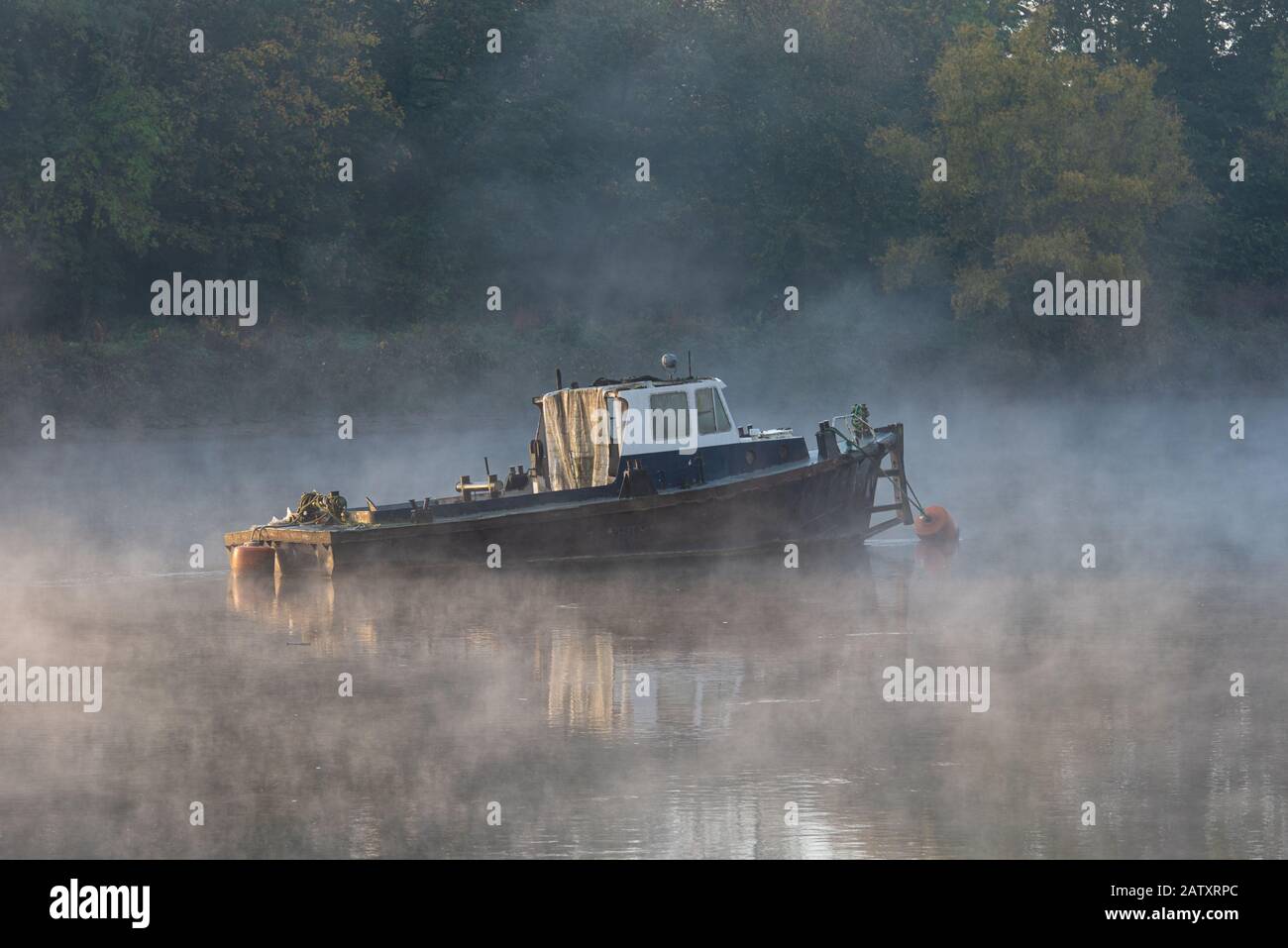 Boat on the River Thames in the fog. Stock Photo