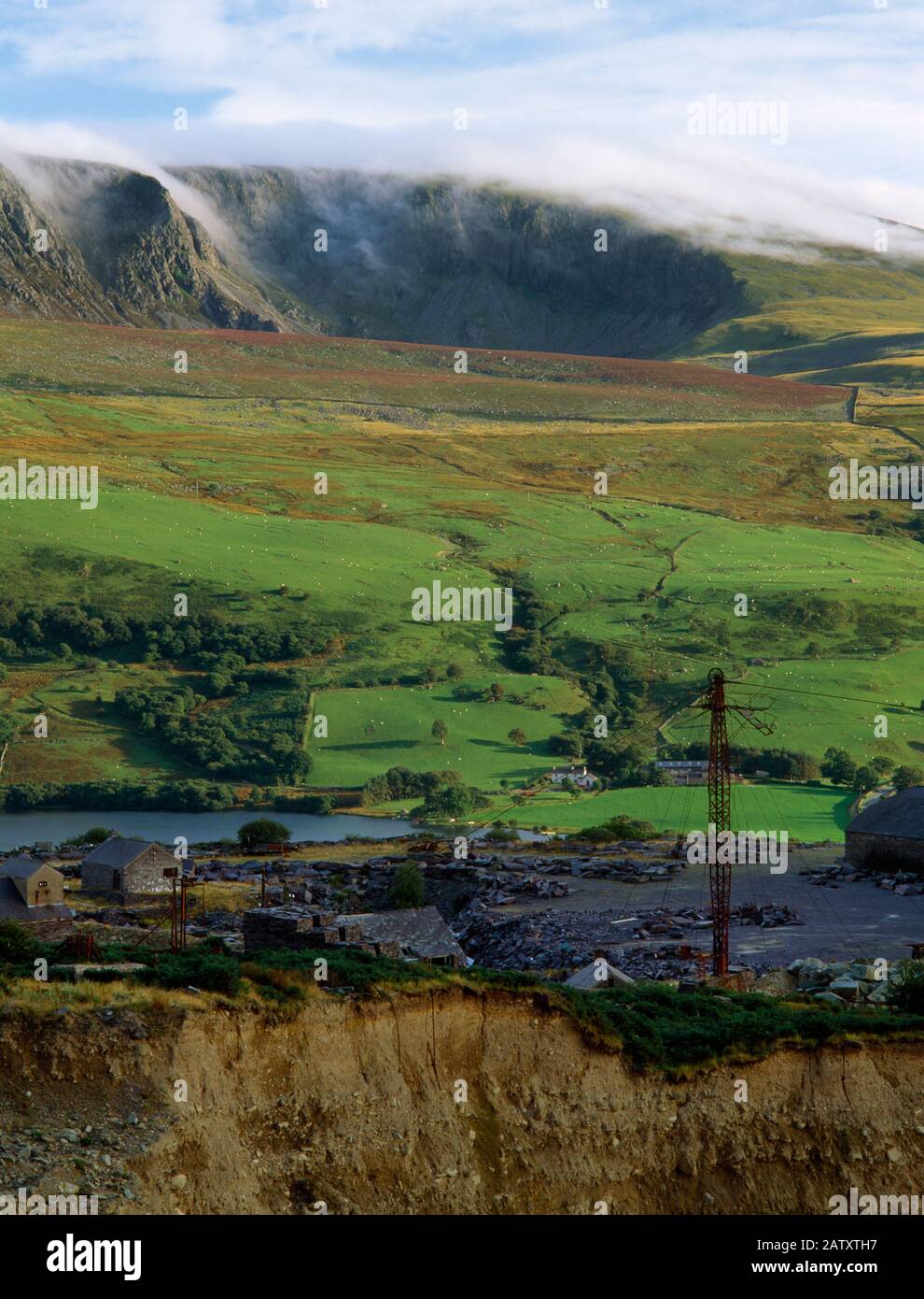View S across Pen-yr-Orsedd slate quarries to the Nantlle Ridge, Wales, UK, showing the pylon, stays & cable of an aerial ropeway (Blondin crane). Stock Photo
