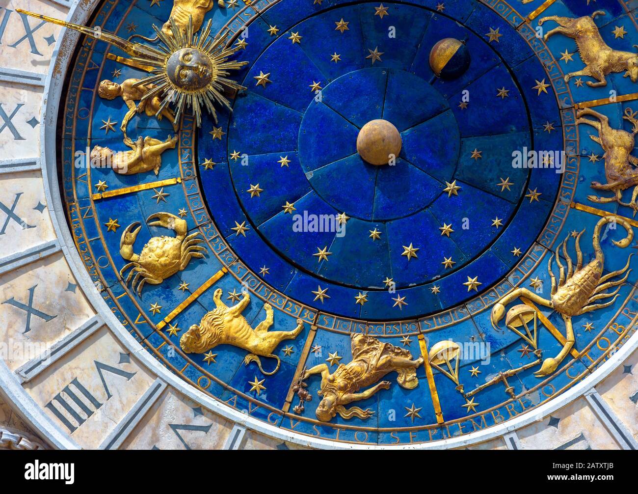 Astrological signs on ancient clock Torre dell'Orologio, Venice, Italy. Medieval Zodiac wheel and constellations. Golden symbols on star circle. Conce Stock Photo