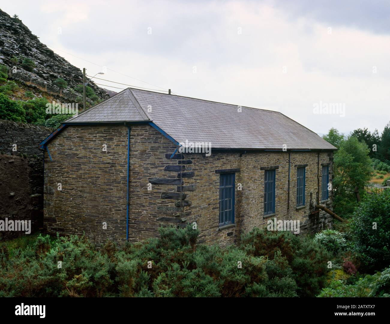 View S of Pant yr Afon hydro-electric power station opened 11 April 1904: original powerhouse for Llechwedd slate quarry, Blaenau Ffestiniog, N Wales. Stock Photo