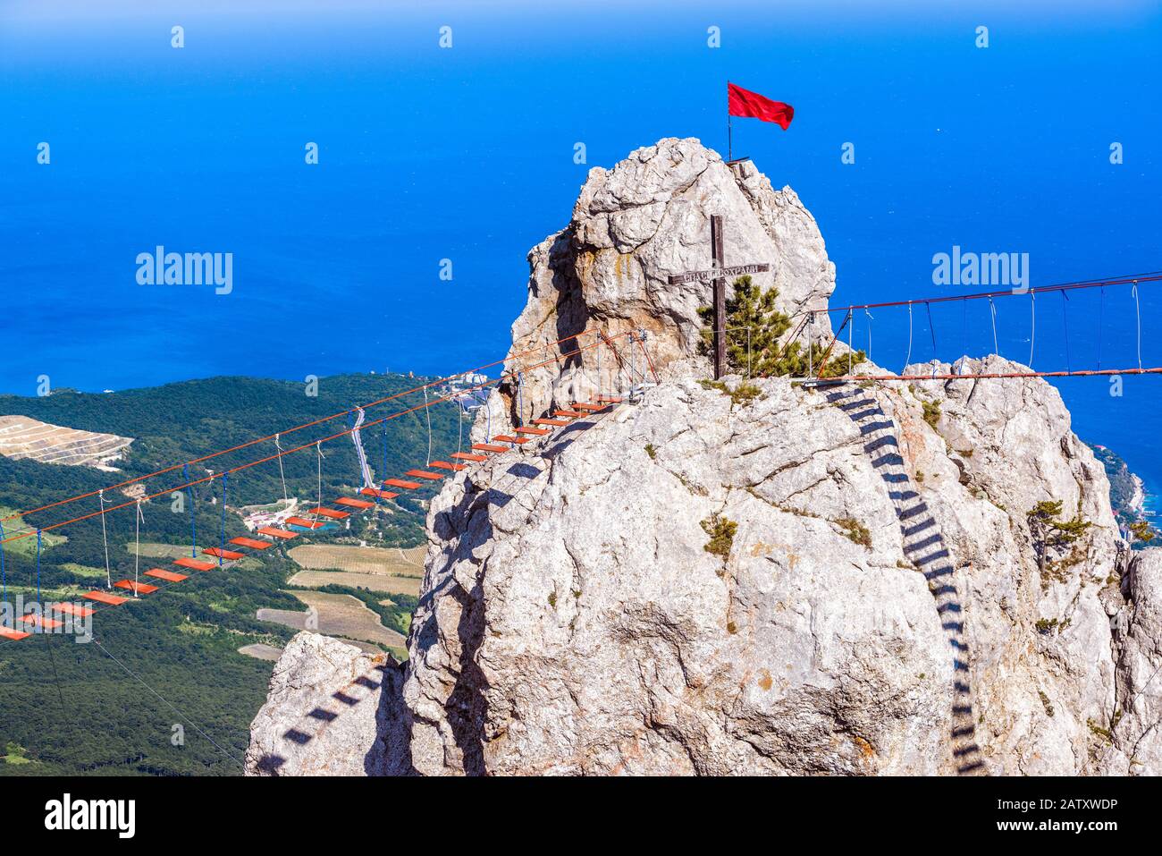 Rock on the Mount Ai-Petri with a rope bridge, Crimea, Russia. It is one of the natural landmarks in Crimea. 'Save and Protect' on a cross. Panorama o Stock Photo