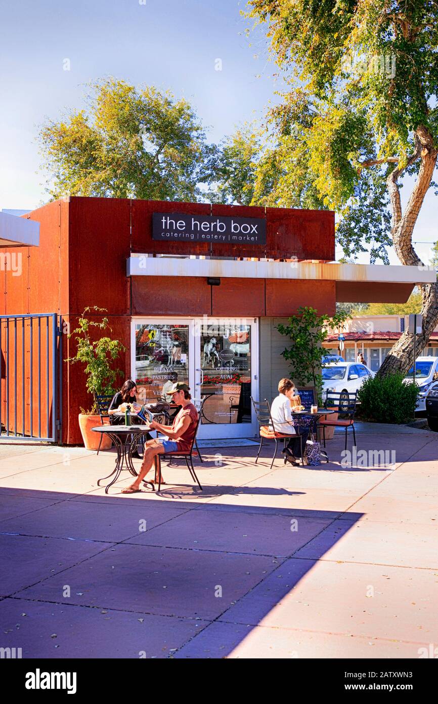 People sitting outside the Herb Box cafe in the 5th Avenue shopping district of Old Town Scottsdale AZ Stock Photo