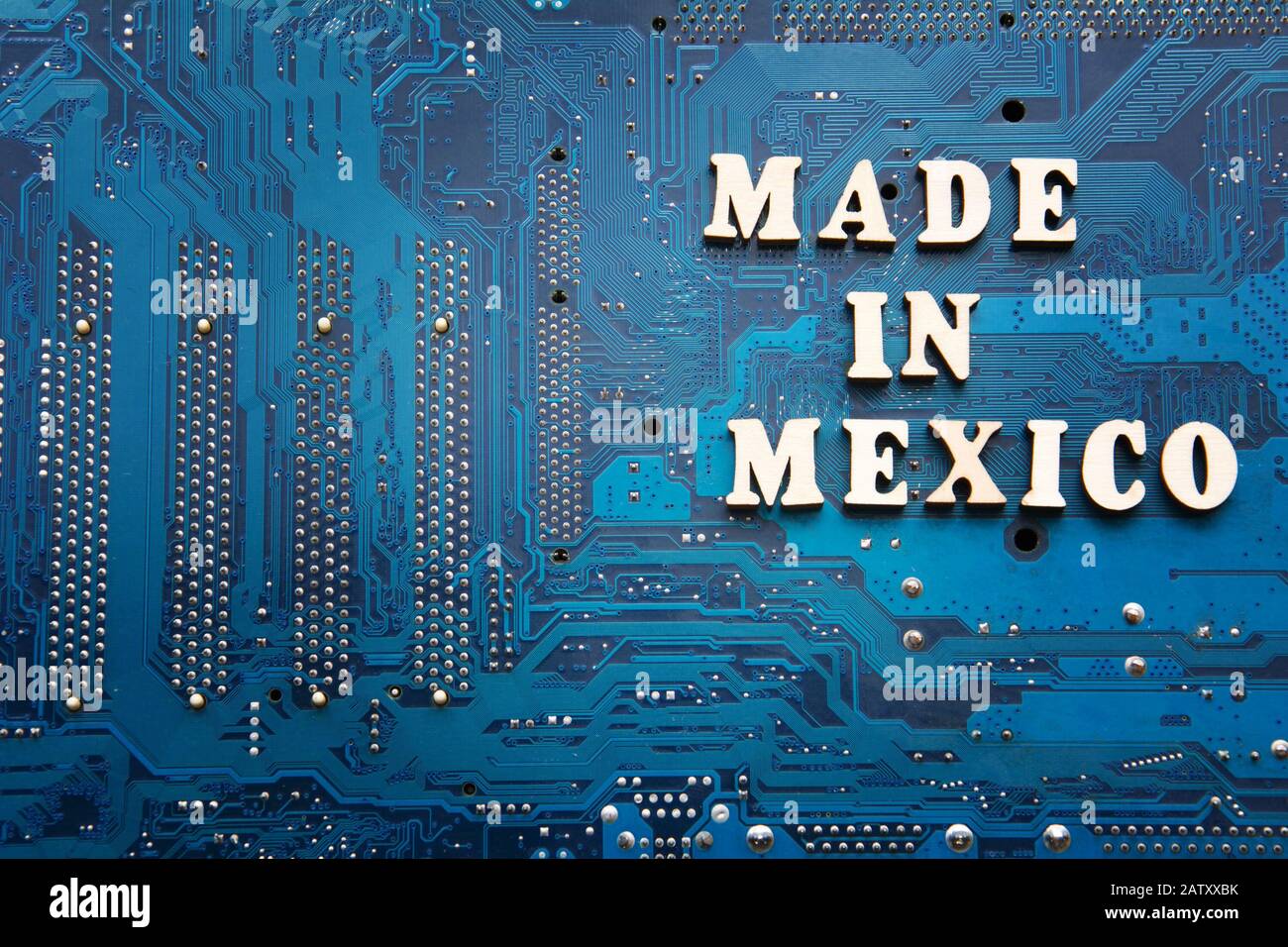 Made in Mexico. Inscription on a blue printed circuit board background. Copyspace for design Stock Photo