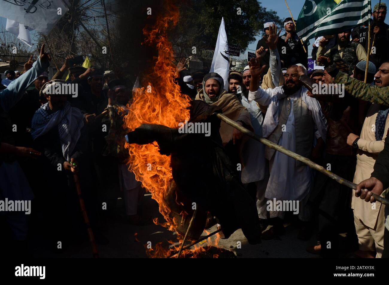 February 5, 2020: Peshawar, Pakistan. 05 February 2020. Pakistanis stage a protest to mark Kashmir Solidarity Day, in the Pakistani city of Peshawar. Participants waved banners and chanted slogans in support of India administered Kashmir and Kasmiris' struggle for their right to self-determination. The Indian flag and an effigy of Indian President Narendra Modi were set alight during the protest on Wednesday. Children also joined the rally waving Pakistan and the Azad Jammu and Kashmir flag in solidarity with the Kashmiris. The Indian State of Jammu and Kashmir has been under severe restrict Stock Photo