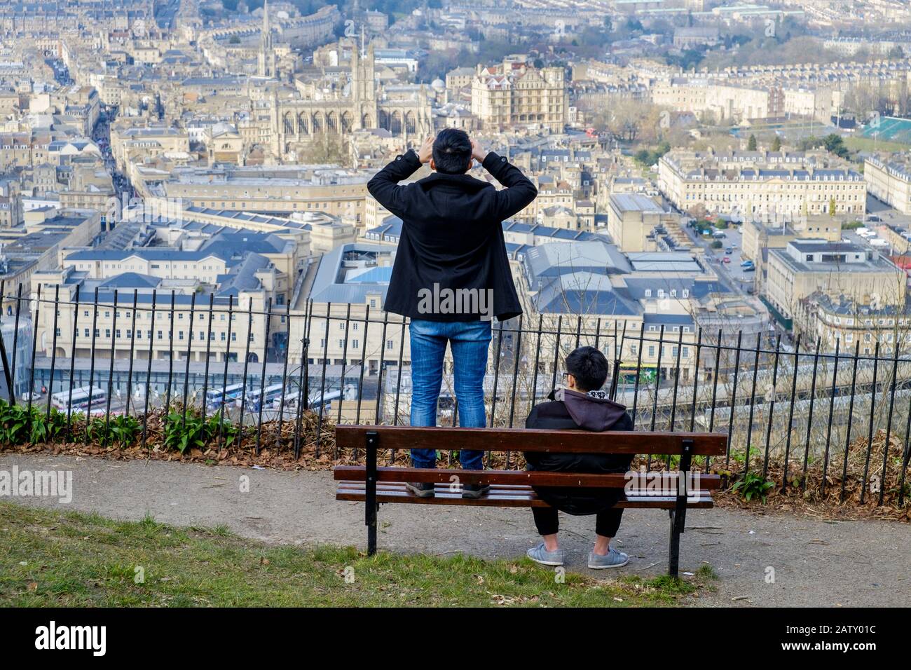 People taking advantage of the high vantage point view are pictured in Alexandra Park looking down at the city of Bath. Bath Somerset England uk Stock Photo