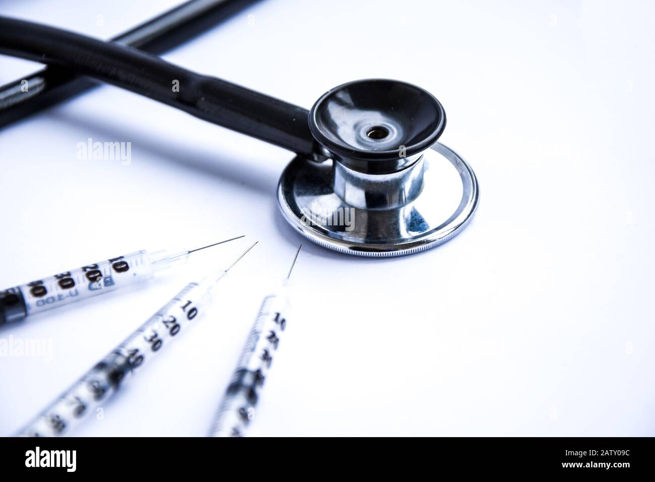 Medical stethoscope with syringes on white background Stock Photo - Alamy