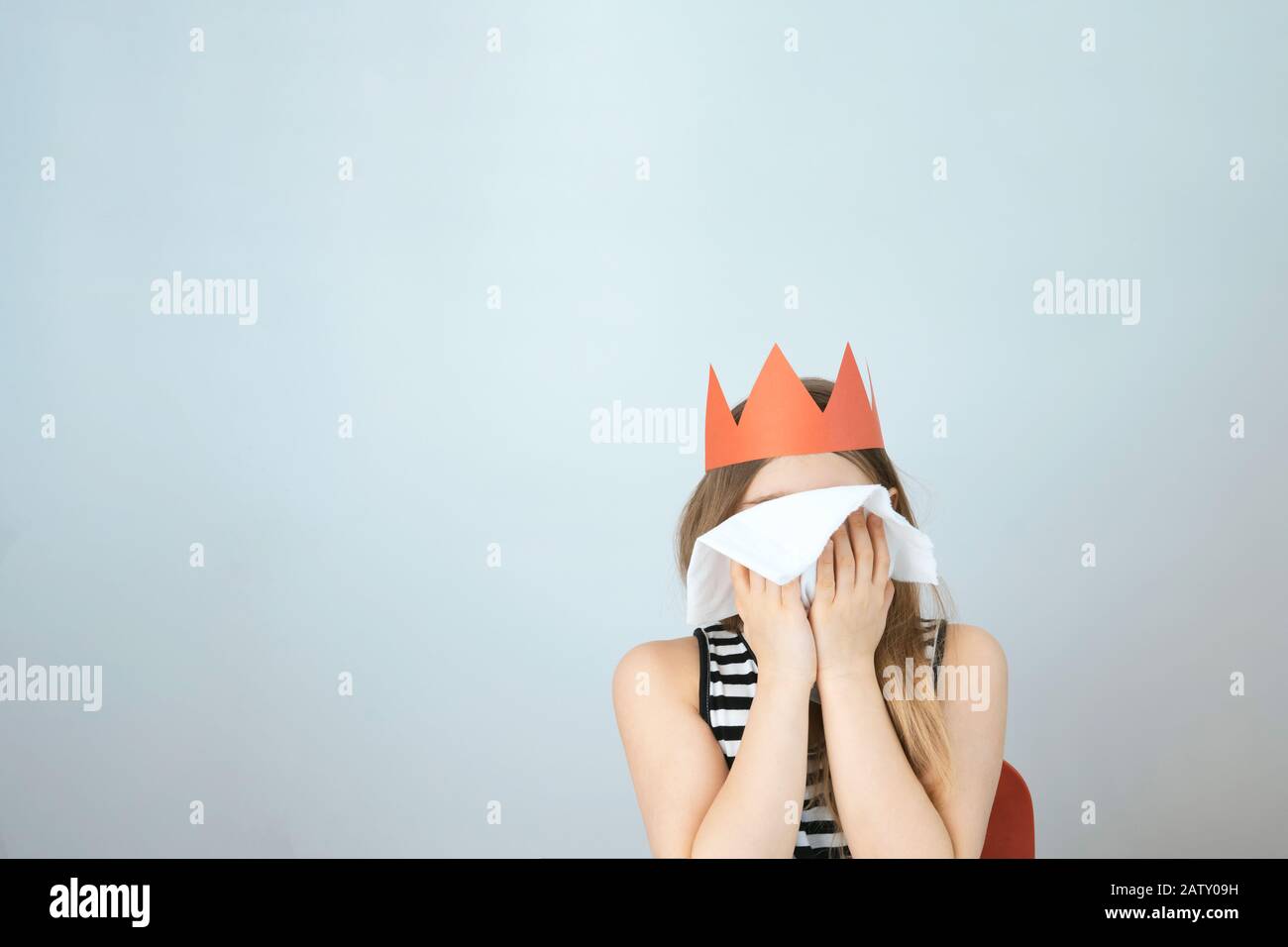 Coronavirus 2019 n-Cov concept. Girl with red crown and white handkerchief. Sars virus. Background with copyspace. Stock photo. Stock Photo