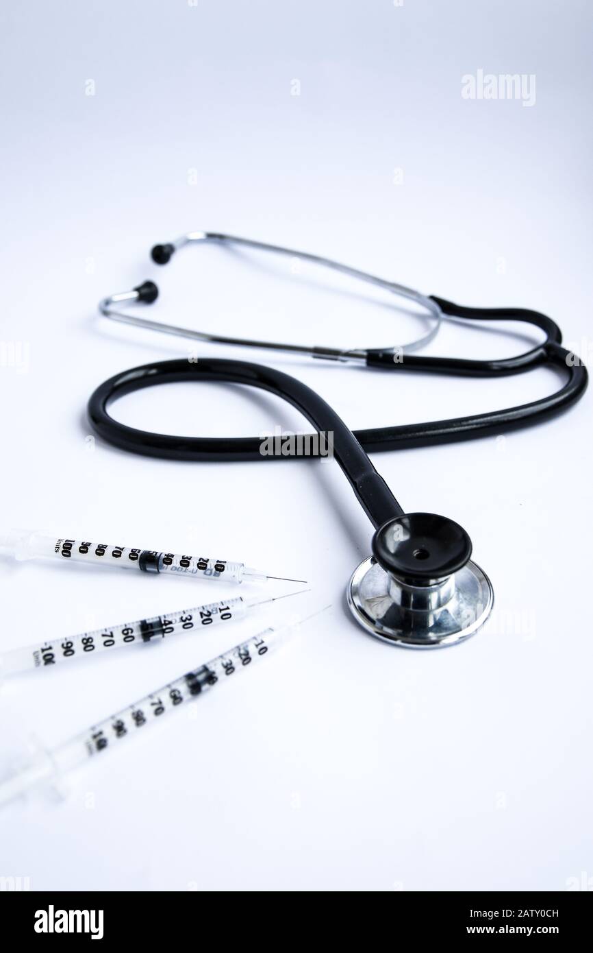 Medical stethoscope with syringes on white background Stock Photo - Alamy
