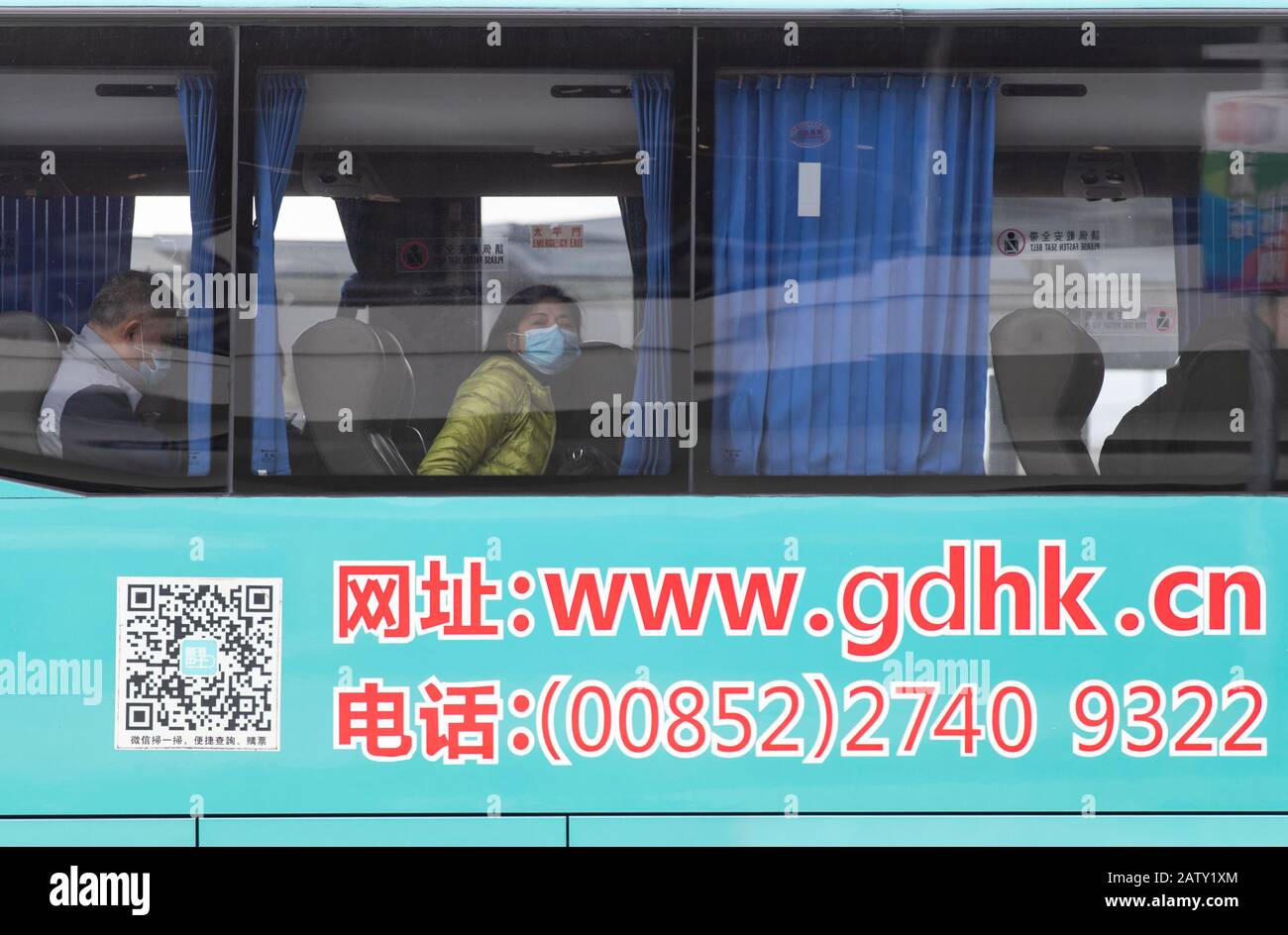 Passengers wearing protective mask on the bus to Zhuhai.Chief Executive Carrie Lam said on Monday that all border crossings would be closed except for the Hong Kong-Zhuhai-Macau Bridge, Shenzhen Bay Port and the HK international airport. Even as the city confirmed its first case of human-to-human corona virus infection. Stock Photo