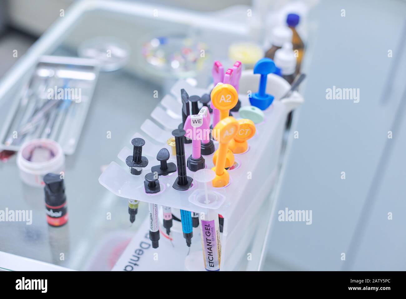 Kyiv UA, 31-07-2019. Close-up of working desk in dentist office with dental composite sealing materials resins, various professional dental instrument Stock Photo
