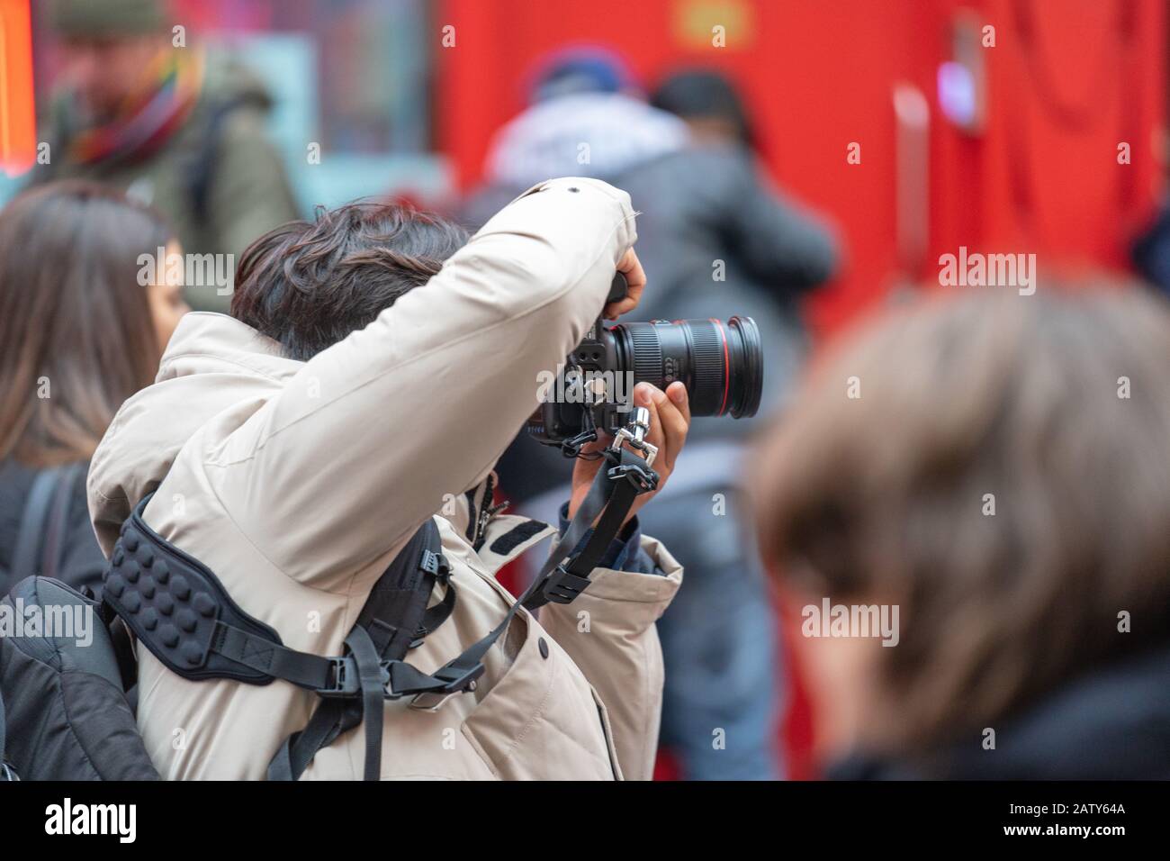 London, January 26, 2020. Photographer taking photos in London Chinatown. Chinese New Year Celebrations. Selective focus Stock Photo