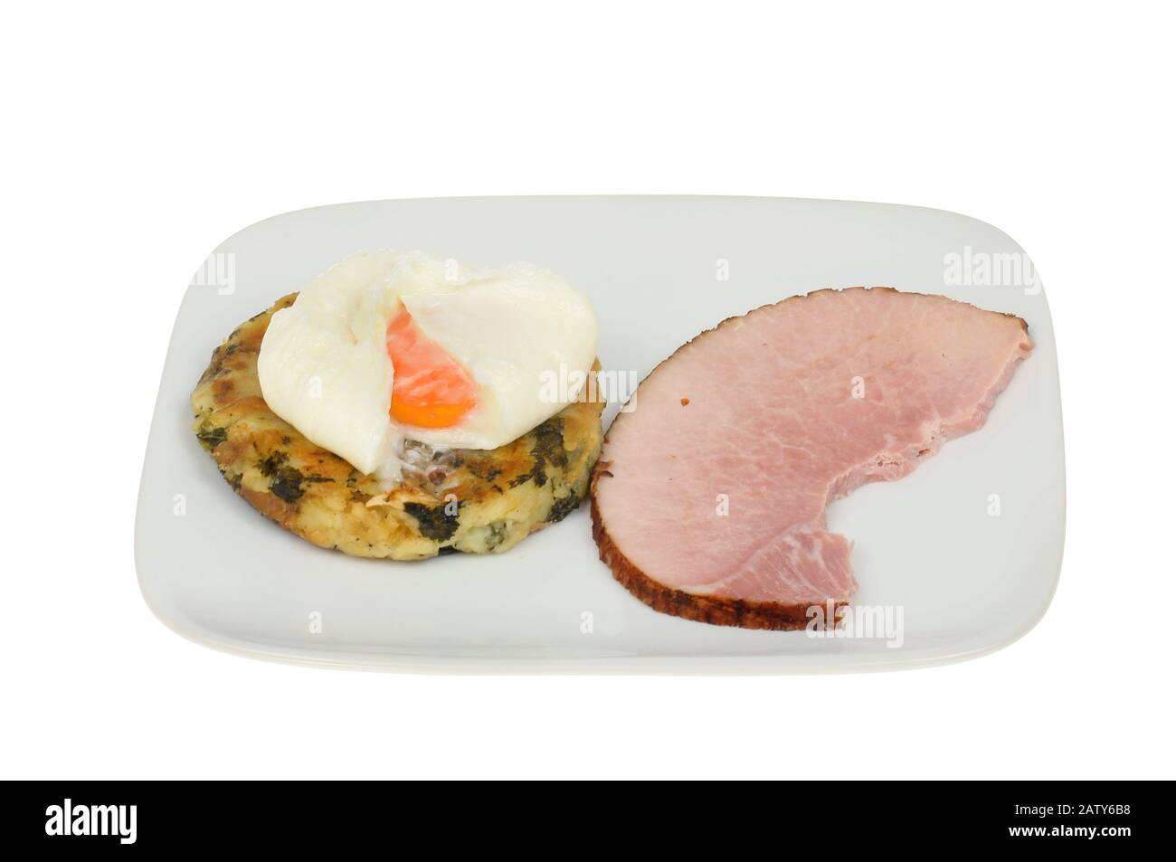 Poached egg, bubble and squeak with ham on a plate isolated against