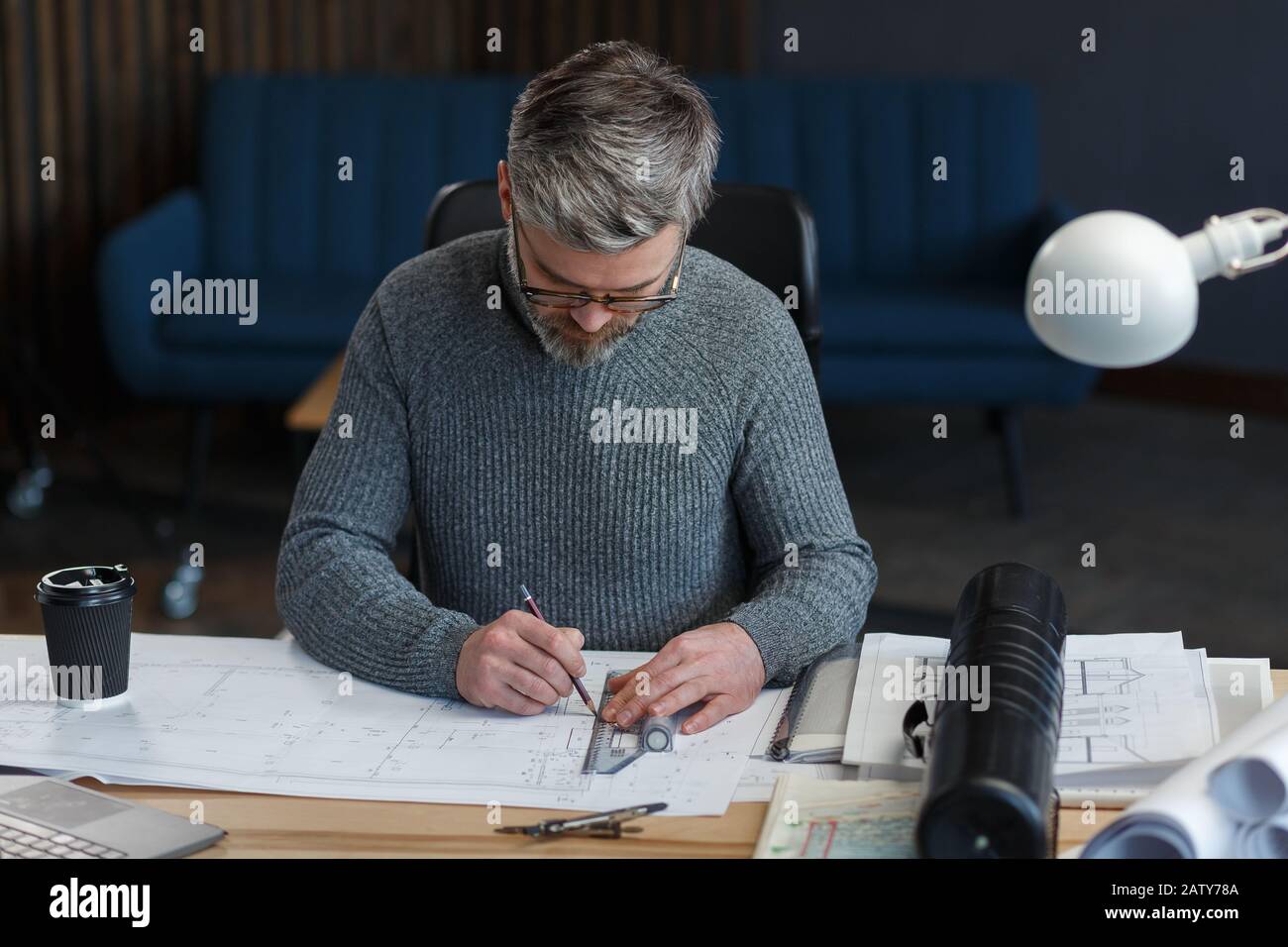 Interior designer working in office with blueprints.Engineer inspect ...