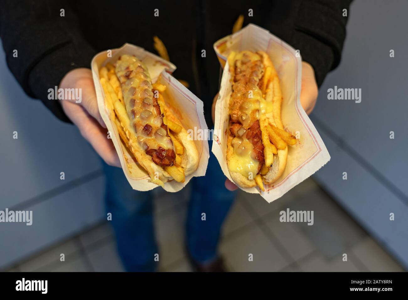 man holding two special icelandic hot dogs Stock Photo