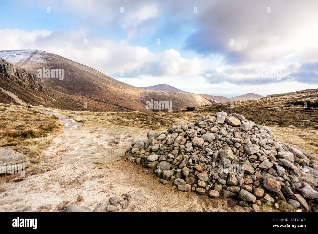Footpath leading to snow capped peak of Slieve Donard mountain. Pile of stones in Mourn Mountains, most dramatic and highest range in Northern Ireland Stock Photo