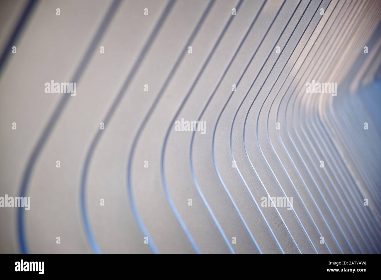 Abstract receding diagonal pattern of a curved metal railing with ...