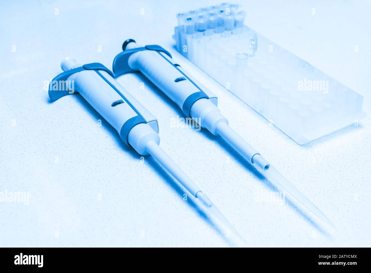 Chemical equipment are on the white background. Automatic pipettes and ...