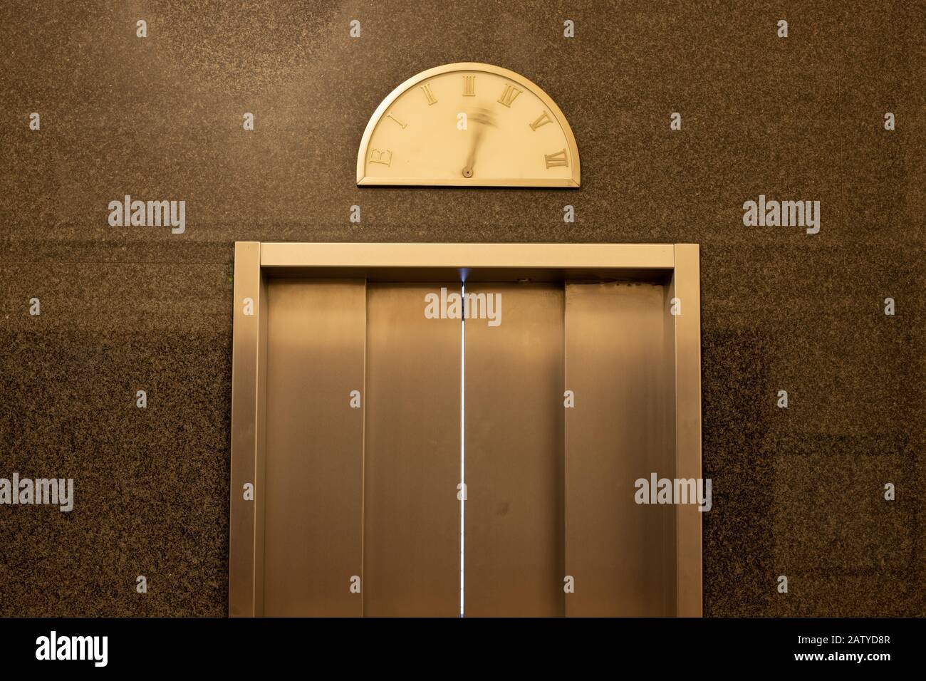 Detail of an elevator door with moving pointer on a vintage floor level