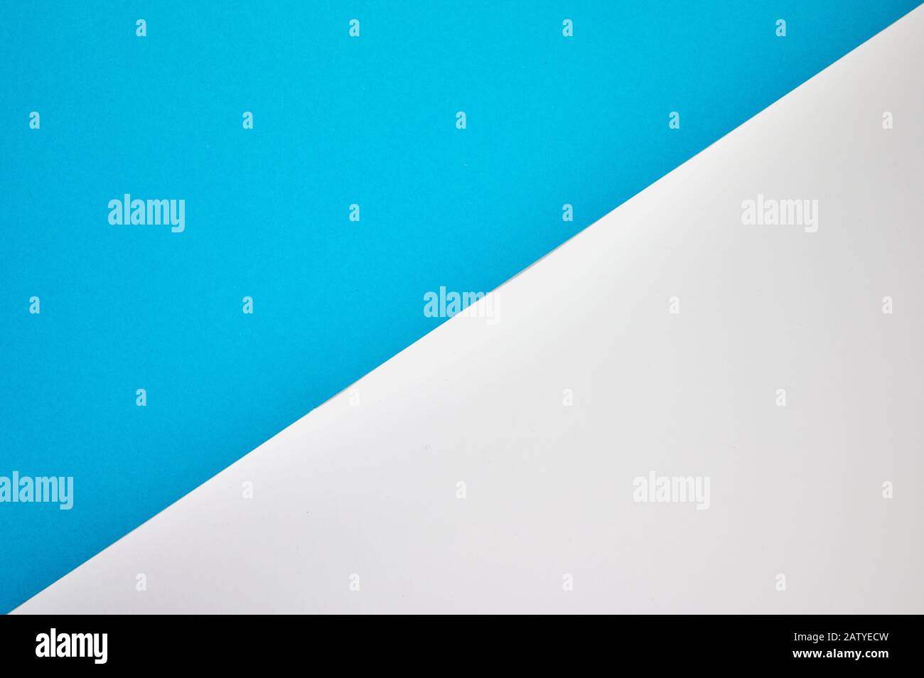 diagonal laid colored paper in blue and white as background photo with copyspace Stock Photo
