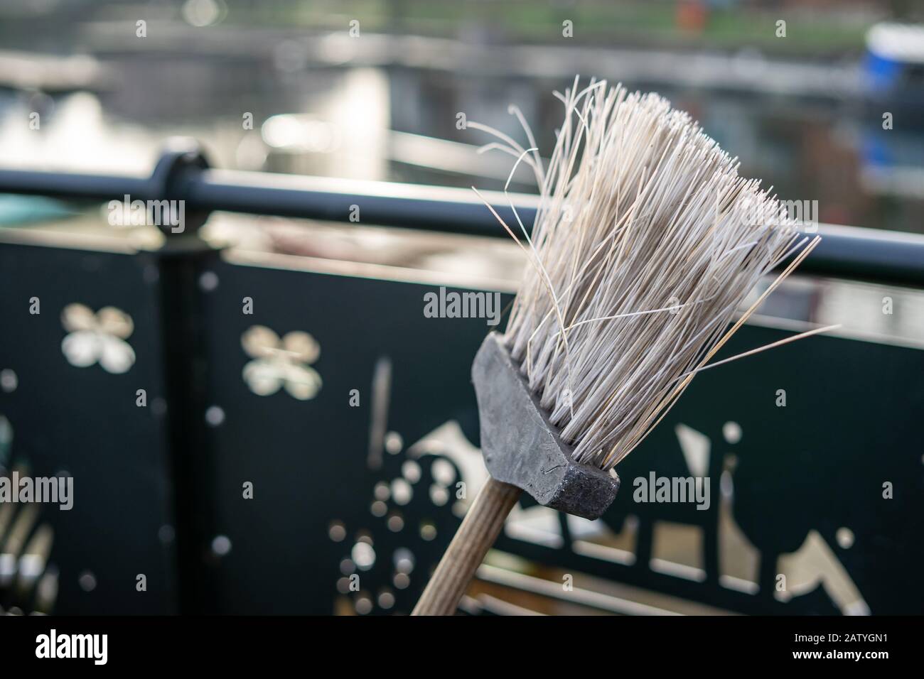 A close up of the head of a road sweepers broom or brush with selective focus on the bristles Stock Photo