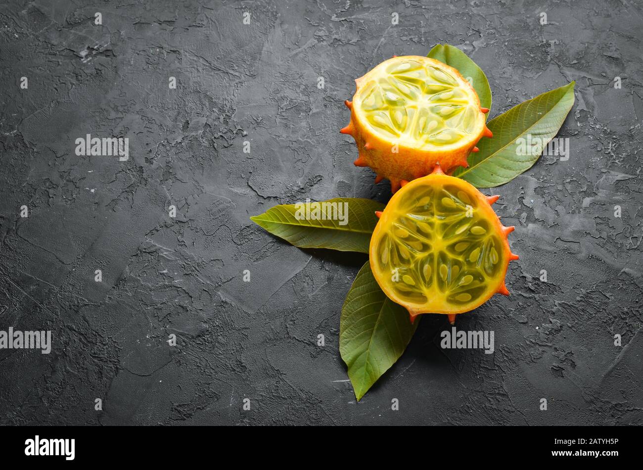 Kiwano on a black background. Tropical Fruits. Top view. Free space for text. Stock Photo