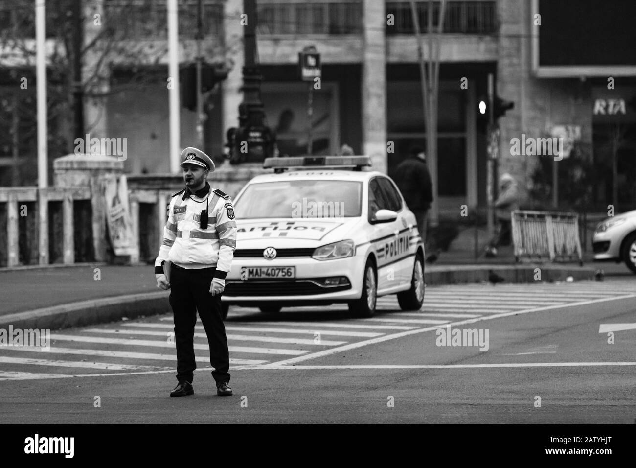 Police agent, Romanian Traffic Police (Politia Rutiera) directing traffic during the morning rush hour in downtown Bucharest, Romania, 2020 Stock Photo