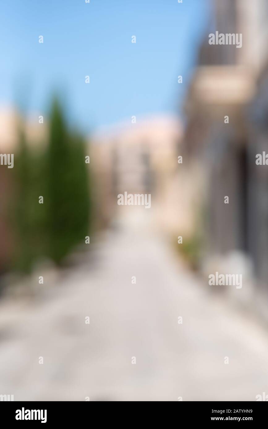Abstract blur background of urban city in summer day, vertical. Deserted street. Stock Photo
